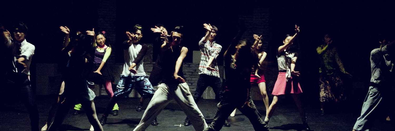 Dance company performing on stage
